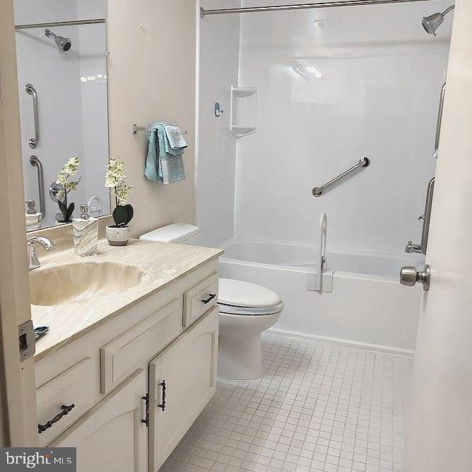 3613 Edelmar Terrace, Unit 131B Silver Spring, MD 20906 - Photo 12 of 24 a bathroom with a granite countertop sink a toilet and shower