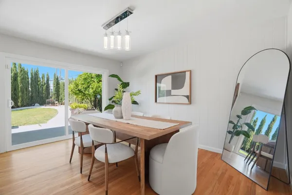 a living room with furniture a lamp and a potted plant