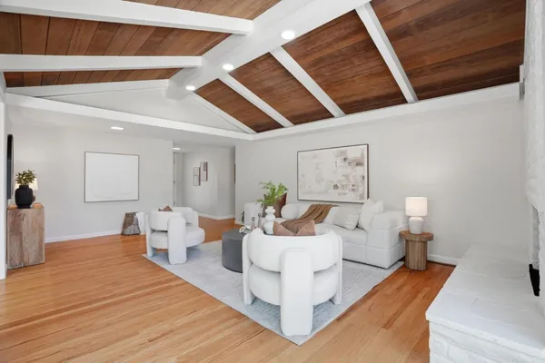 a bedroom with a large bed and a potted plant