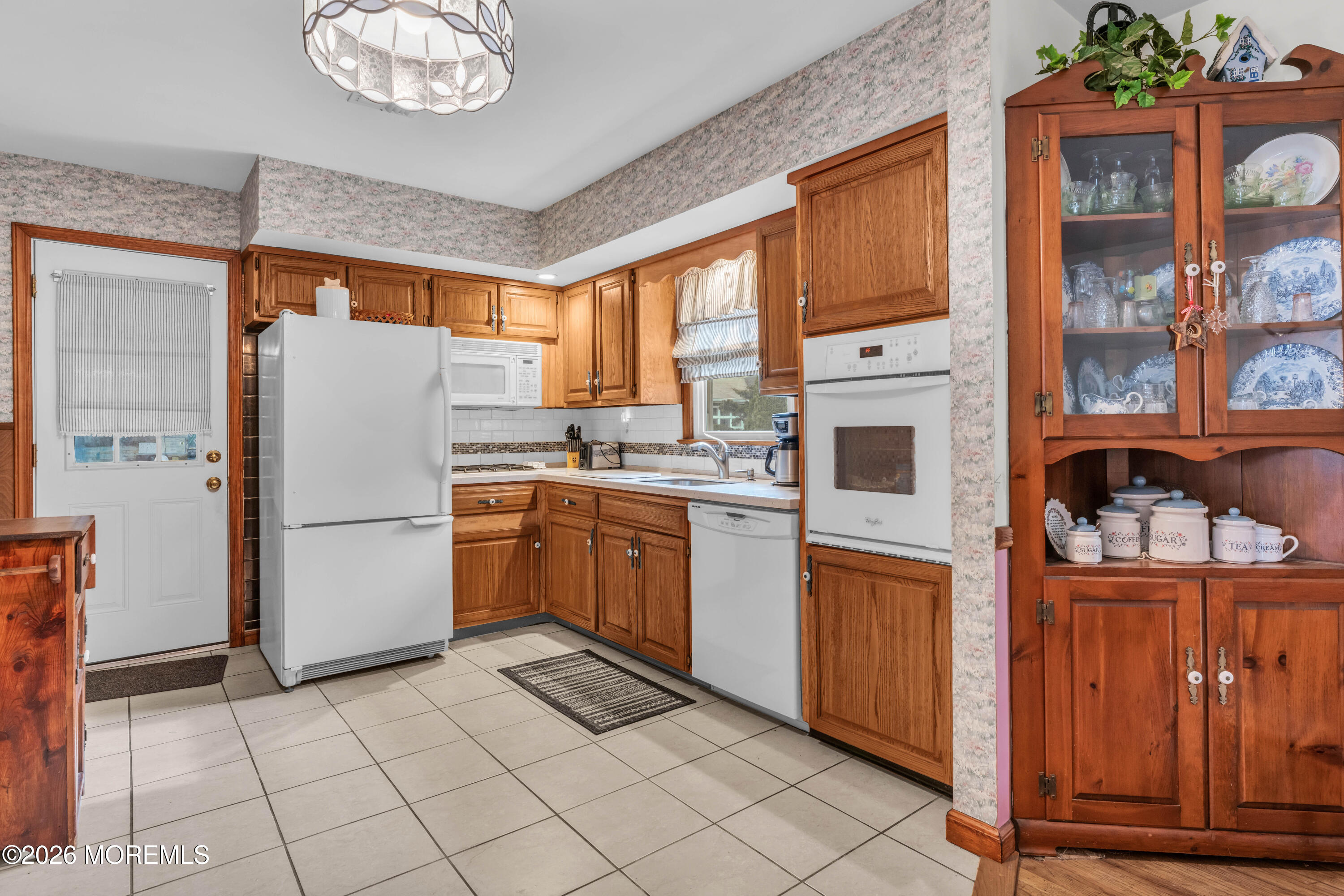 511 Robin Hood Road Brick, NJ 08724 - Photo 3 of 30 a kitchen with a refrigerator a stove top oven a sink and cabinets