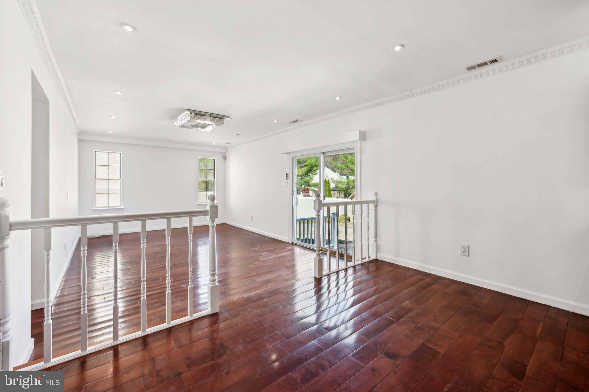 1986 Greentree Road Cherry Hill, NJ 08003 - Photo 11 of 25 an empty room with wooden floor and windows