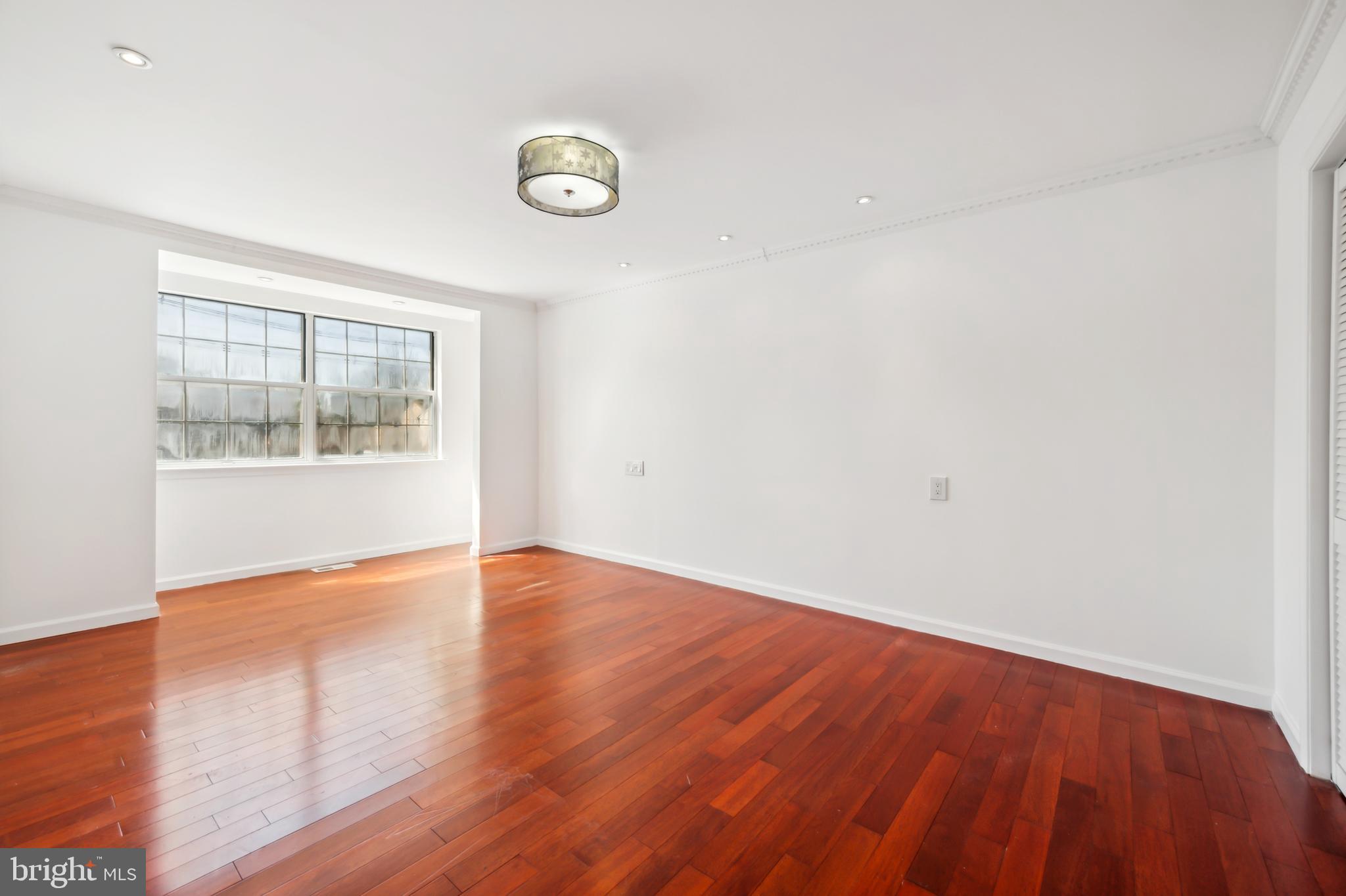 1986 Greentree Road Cherry Hill, NJ 08003 - Photo 19 of 25 an empty room with wooden floor and windows