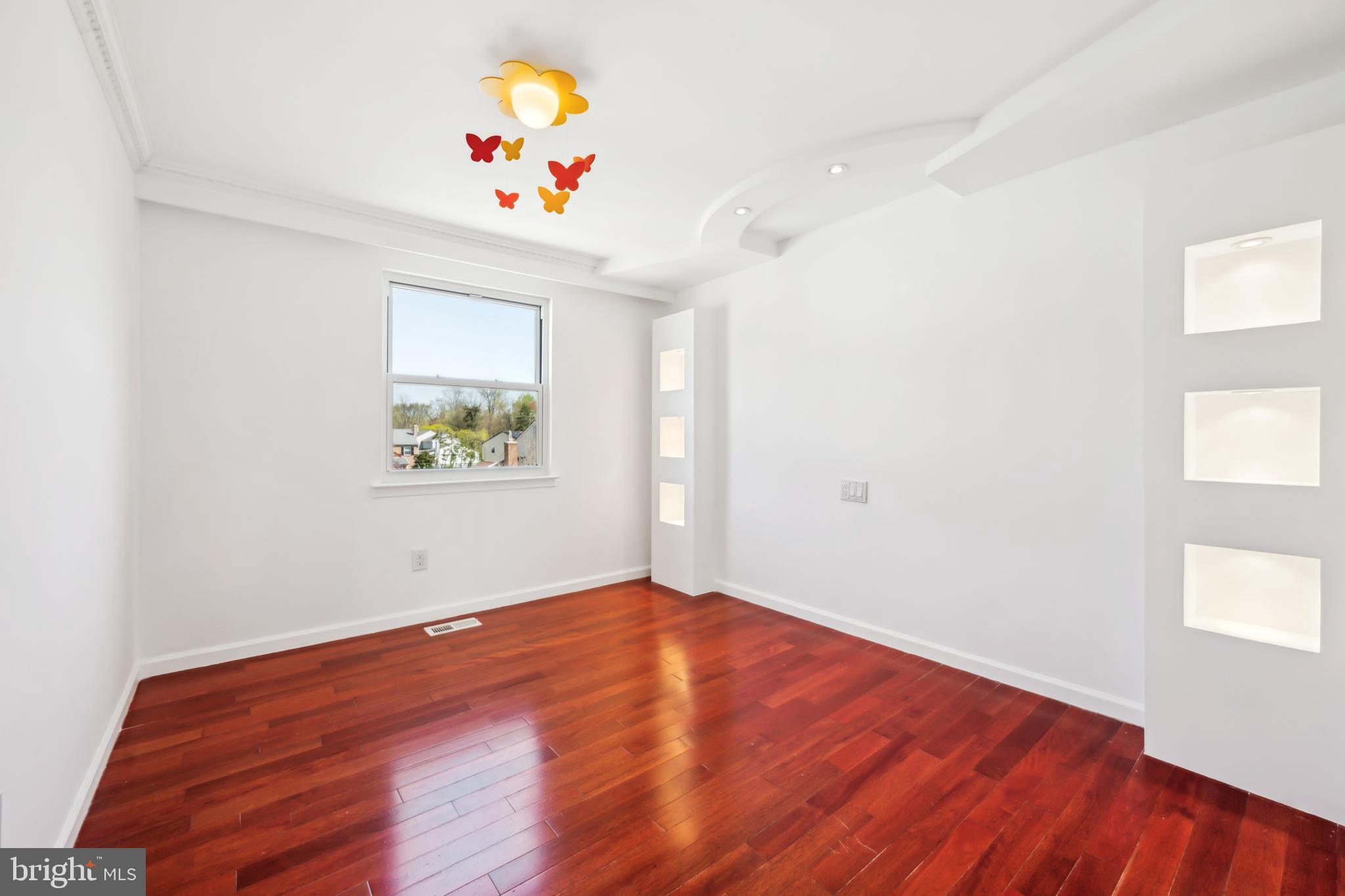 1986 Greentree Road Cherry Hill, NJ 08003 - Photo 21 of 25 an empty room with a window and wooden floor