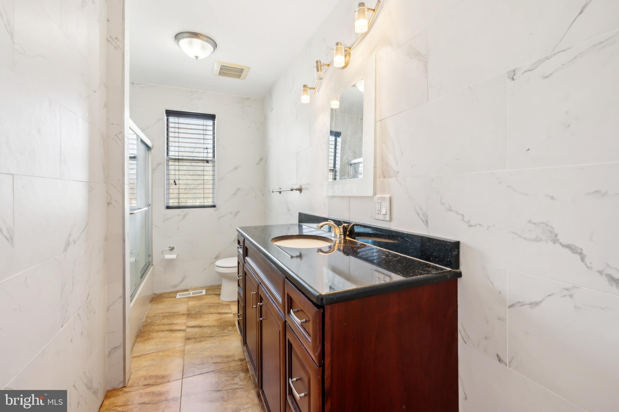 1986 Greentree Road Cherry Hill, NJ 08003 - Photo 22 of 25 a bathroom with a sink a vanity and mirror