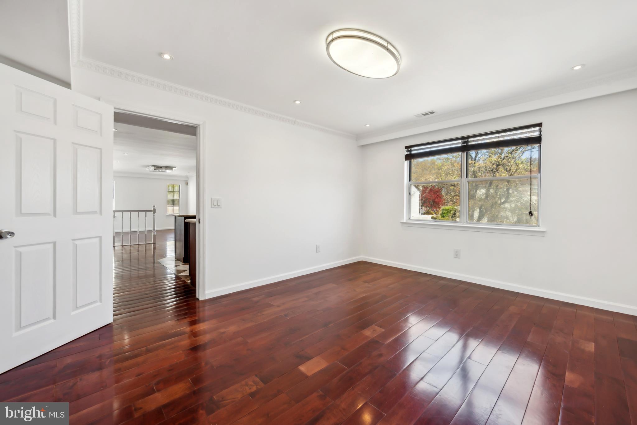 1986 Greentree Road Cherry Hill, NJ 08003 - Photo 5 of 25 an empty room with wooden floor and windows
