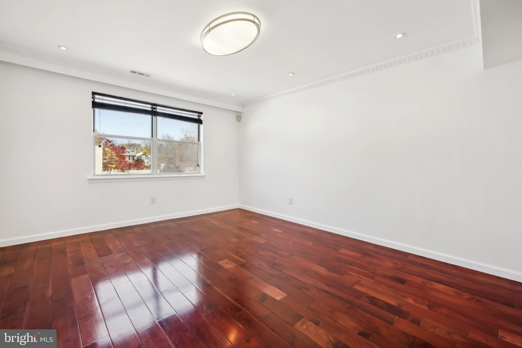 1986 Greentree Road Cherry Hill, NJ 08003 - Photo 6 of 25 an empty room with wooden floor and windows