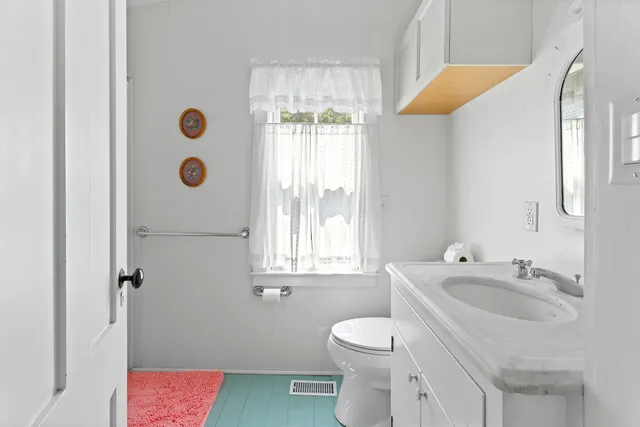 a bathroom with a sink a toilet and tub