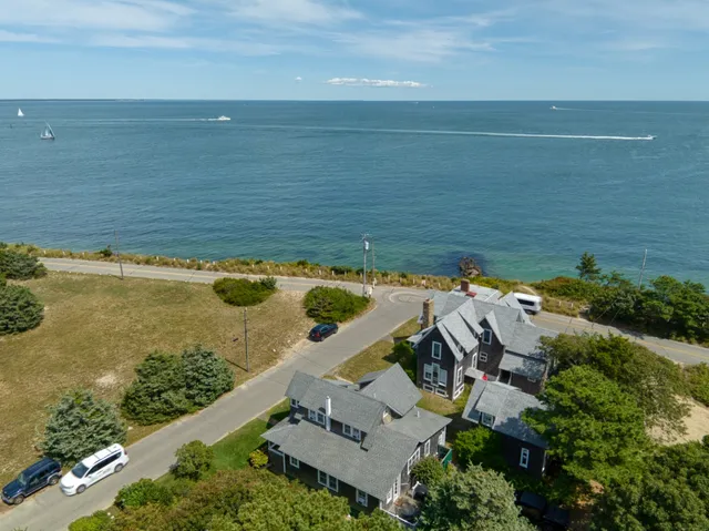 an aerial view of ocean with residential house