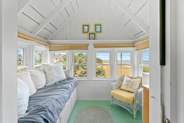 a spacious bedroom with a bed and a couch next to a window