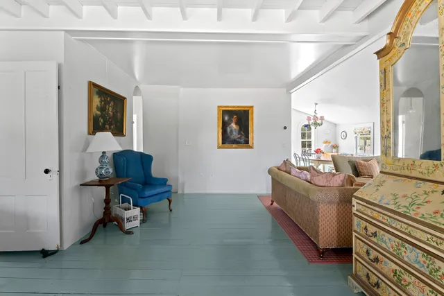 a living room with furniture and a entryway
