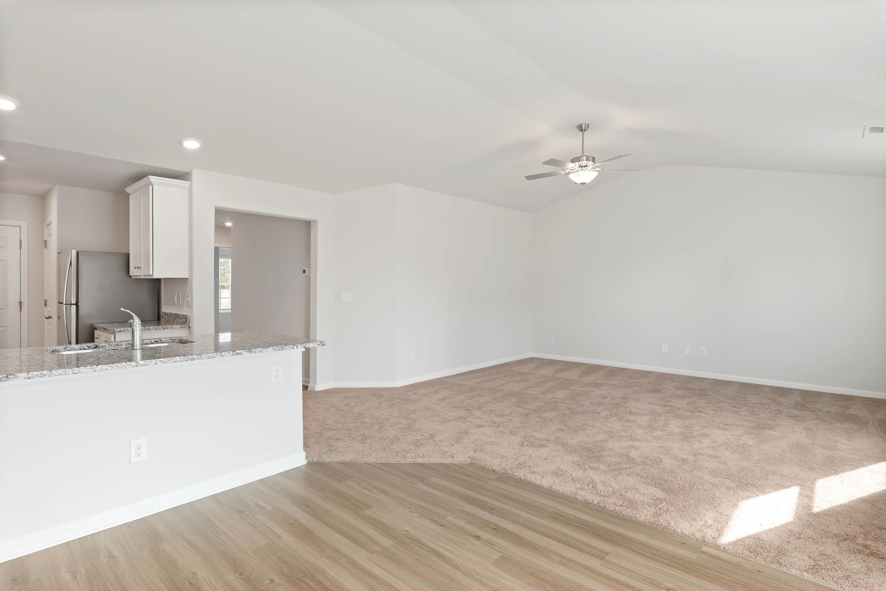 96 Crow Field Street Roxboro, NC 27574 - Photo 12 of 17 a view of a kitchen with kitchen island a sink stainless steel appliances and cabinets