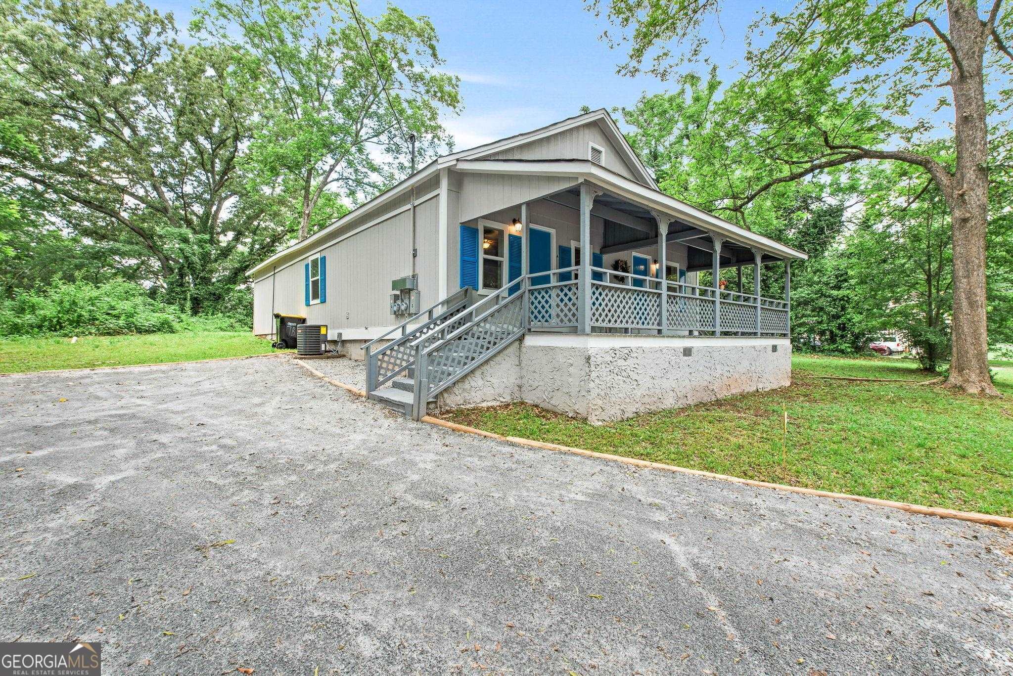 7 Burdette Place, Unit A Newnan, GA 30263 - Photo 2 of 18 a view of a house with a yard and large tree