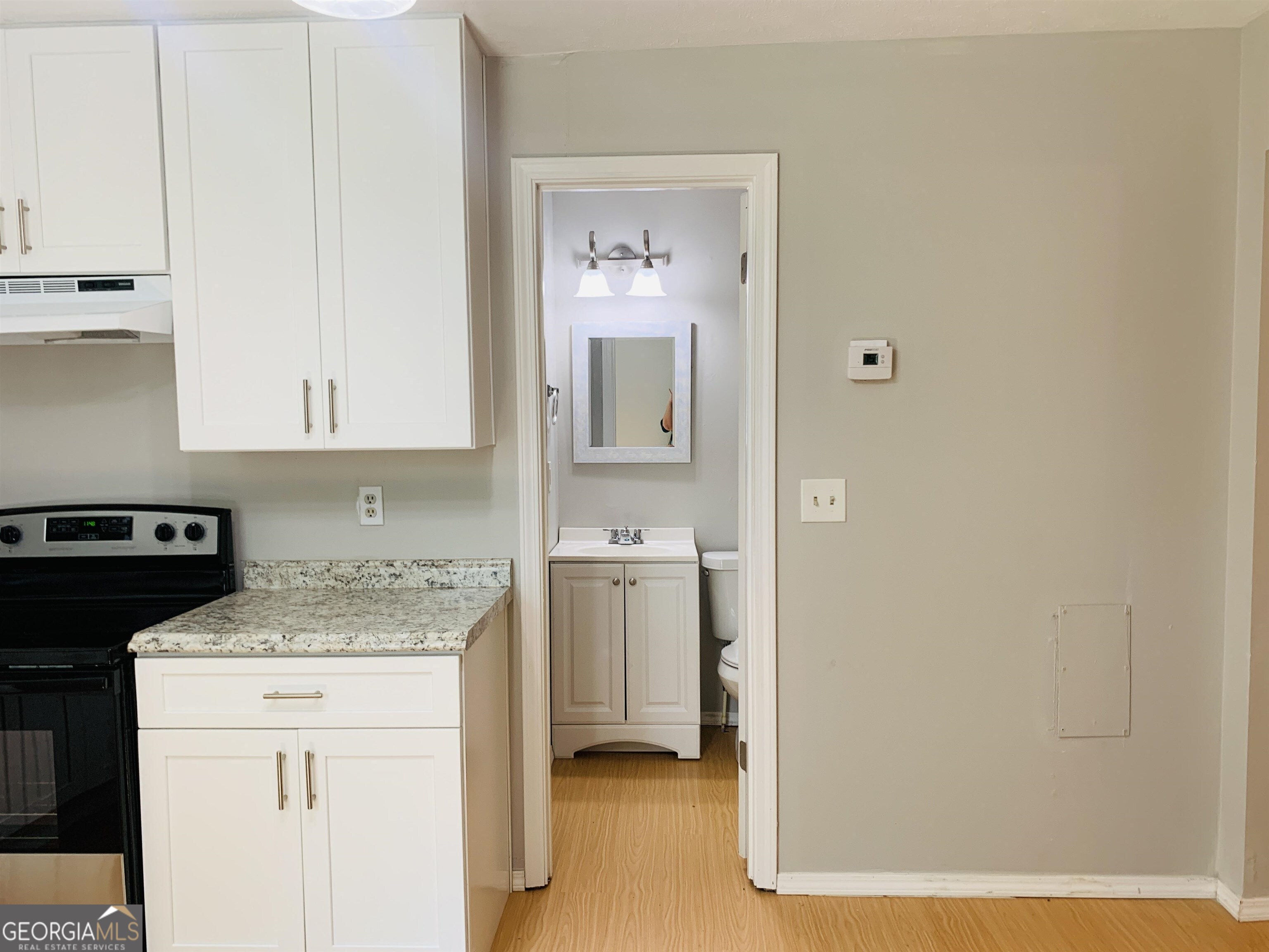 7 Burdette Place, Unit A Newnan, GA 30263 - Photo 10 of 18 a kitchen with a sink and a refrigerator