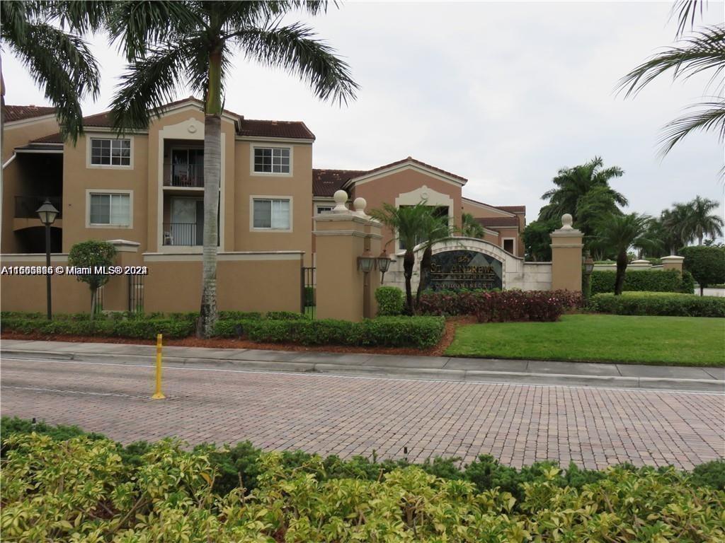 8050 North Nob Hill Road, Unit 201 Tamarac, FL 33321 - Photo 1 of 16 a front view of a house with a yard and garage