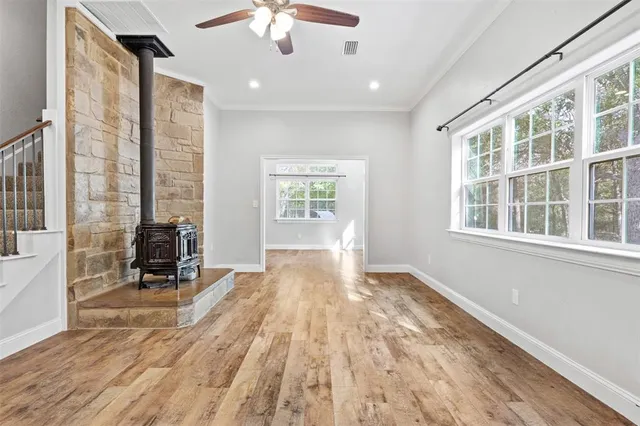 a view of a livingroom with wooden floor and staircase