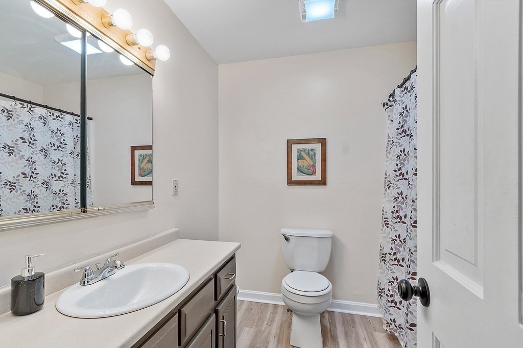 11 Labrecque Street, Unit 3 Manchester, NH 03102 - Photo 11 of 27 a bathroom with a sink toilet and a mirror