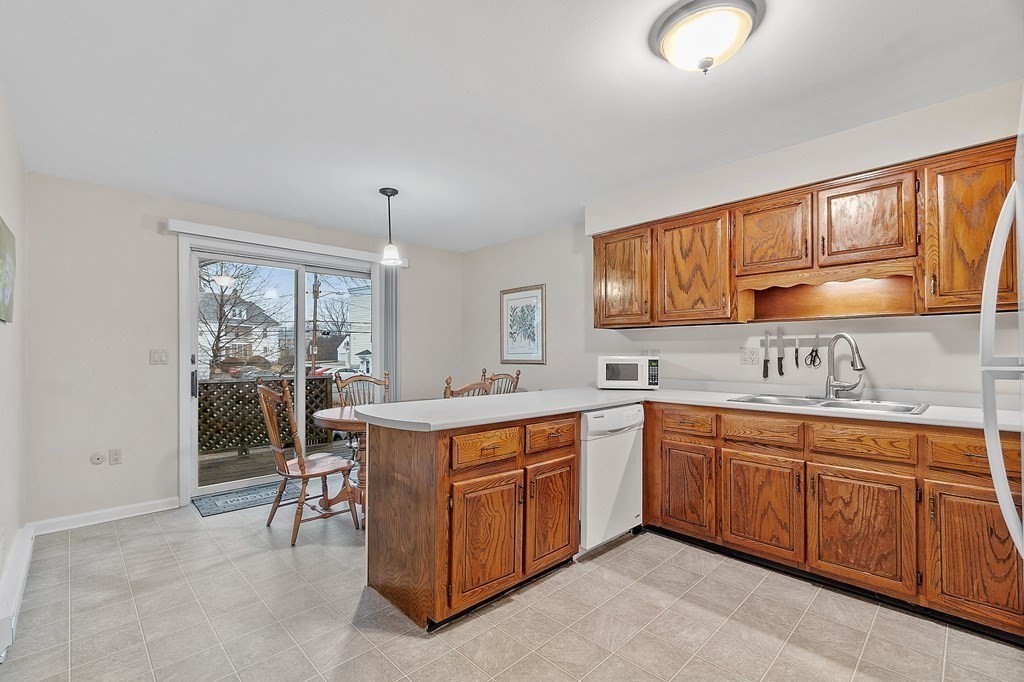 11 Labrecque Street, Unit 3 Manchester, NH 03102 - Photo 8 of 27 a kitchen that has a sink and chairs in it