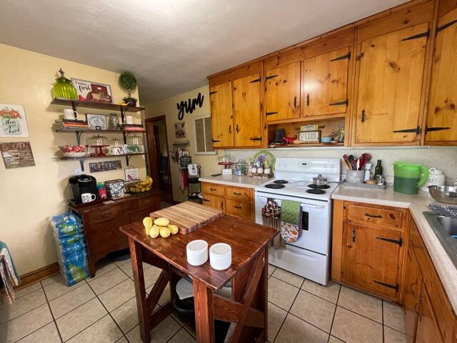 119 Robertson Ridge Road Axton, VA 24054 - Photo 8 of 25 a open kitchen with stainless steel appliances granite countertop a stove a sink dishwasher and cabinets with wooden floor