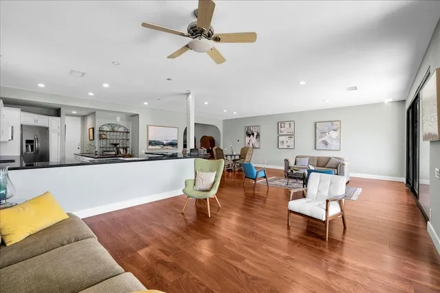 a living room with a large window and a wooden floor