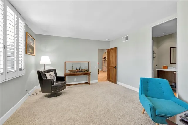 a bathroom with a sink vanity mirror and toilet