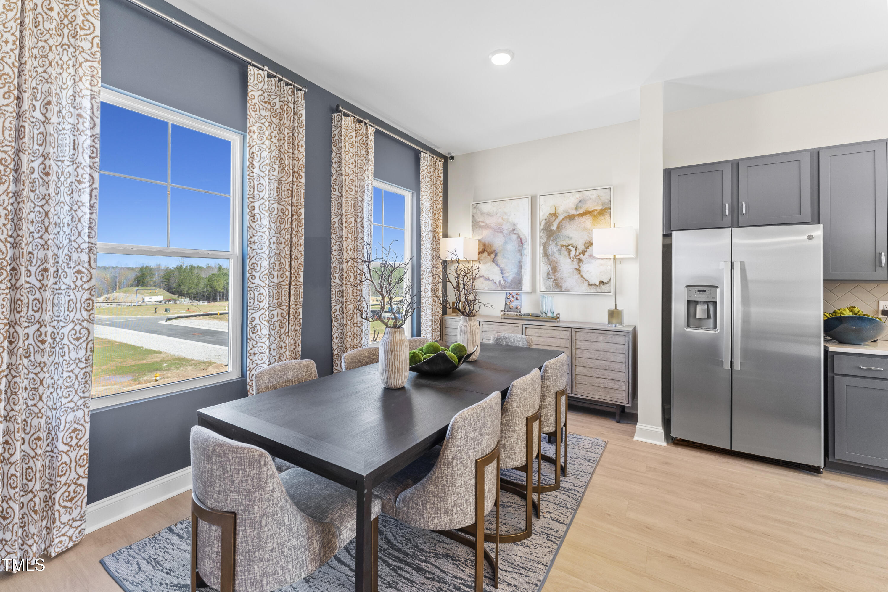 2722 Kempthorne Road Cary, NC 27519 - Photo 12 of 40 a kitchen with stainless steel appliances a dining table chairs and a refrigerator