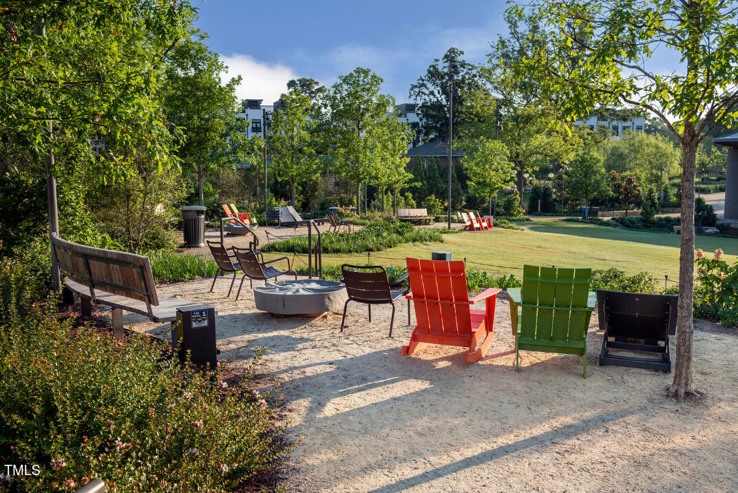 2722 Kempthorne Road Cary, NC 27519 - Photo 31 of 40 a view of a patio with table and chairs potted plants and a large tree
