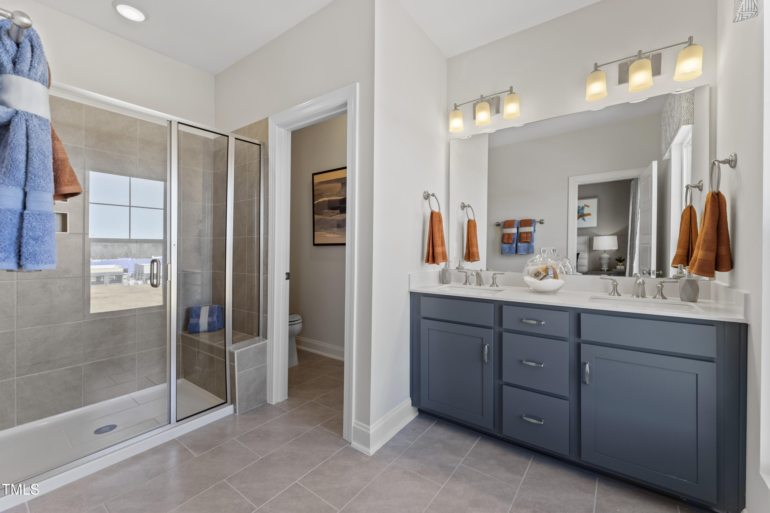 2722 Kempthorne Road Cary, NC 27519 - Photo 7 of 40 a spacious bathroom with a shower sink and mirror