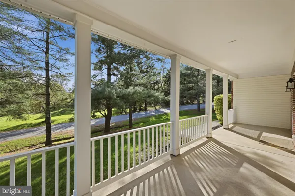 a living room with furniture a fireplace and a ceiling fan