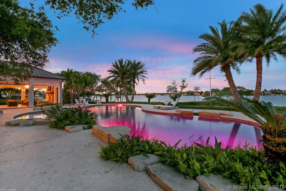 5241 Pennock Point Road Jupiter, FL 33458 - Photo 12 of 51 a view of swimming pool with outdoor seating and palm tree