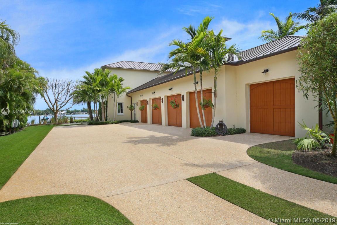 5241 Pennock Point Road Jupiter, FL 33458 - Photo 16 of 51 a white house with a yard and potted plants