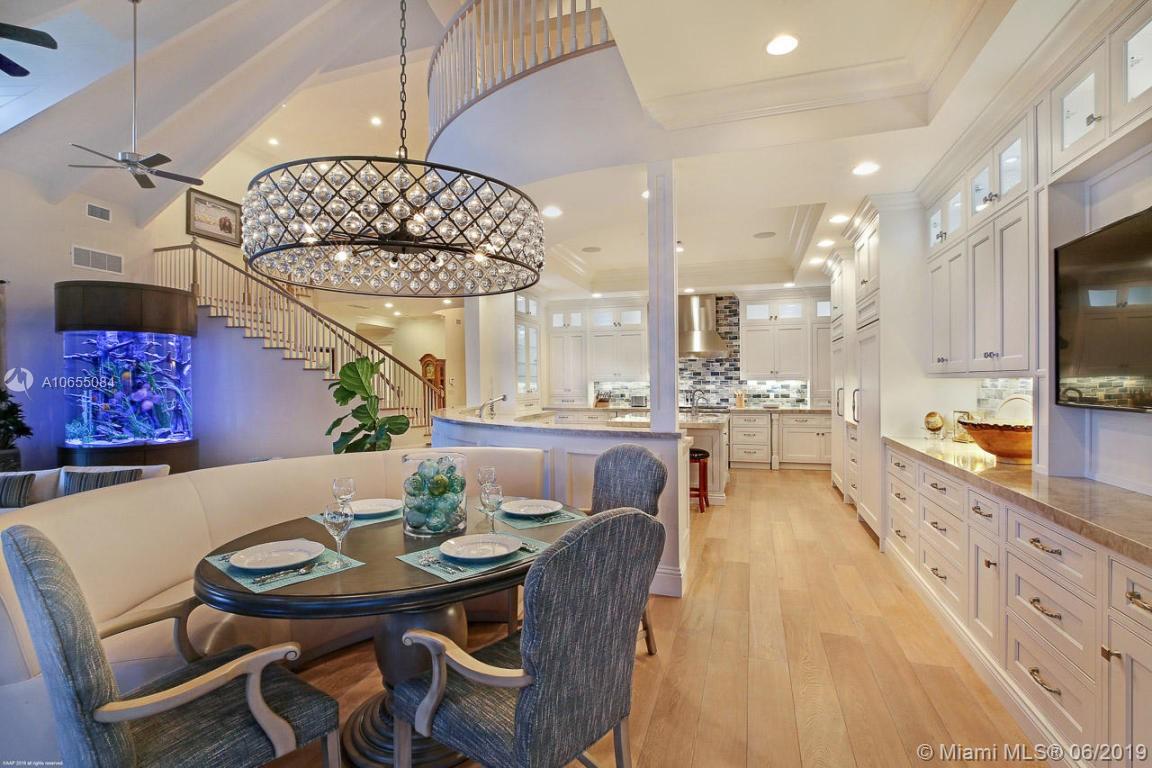 5241 Pennock Point Road Jupiter, FL 33458 - Photo 19 of 51 a view of a dining room with furniture wooden floor and chandelier