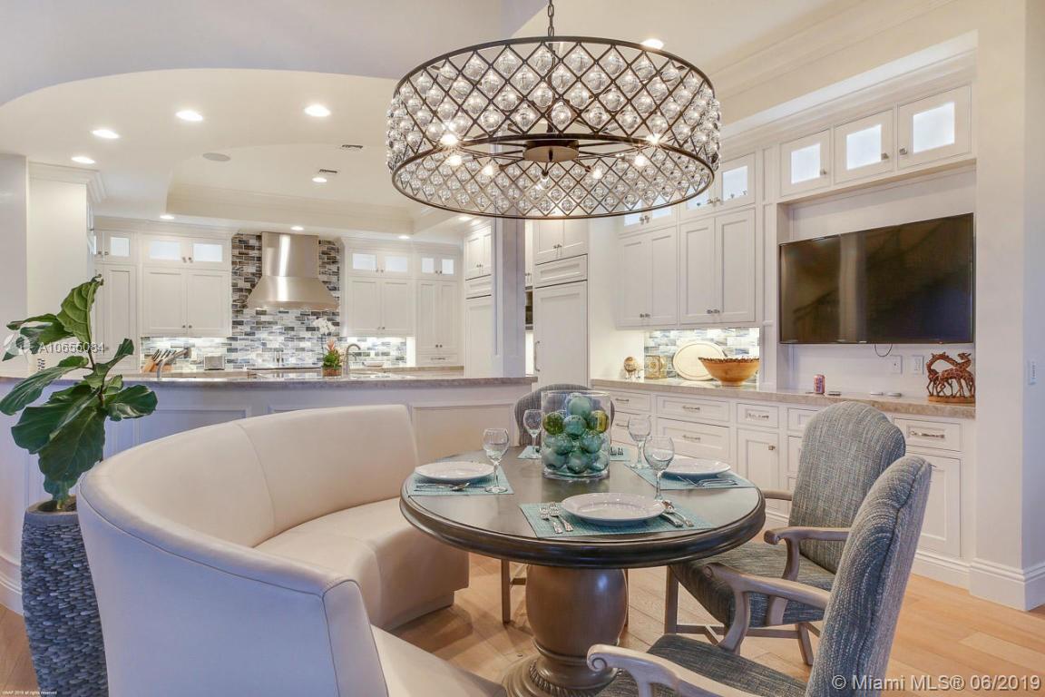 5241 Pennock Point Road Jupiter, FL 33458 - Photo 20 of 51 a living room with dining table and a flat screen tv