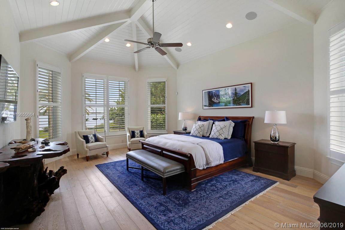 5241 Pennock Point Road Jupiter, FL 33458 - Photo 25 of 51 a spacious bedroom with a bed a couch and large windows