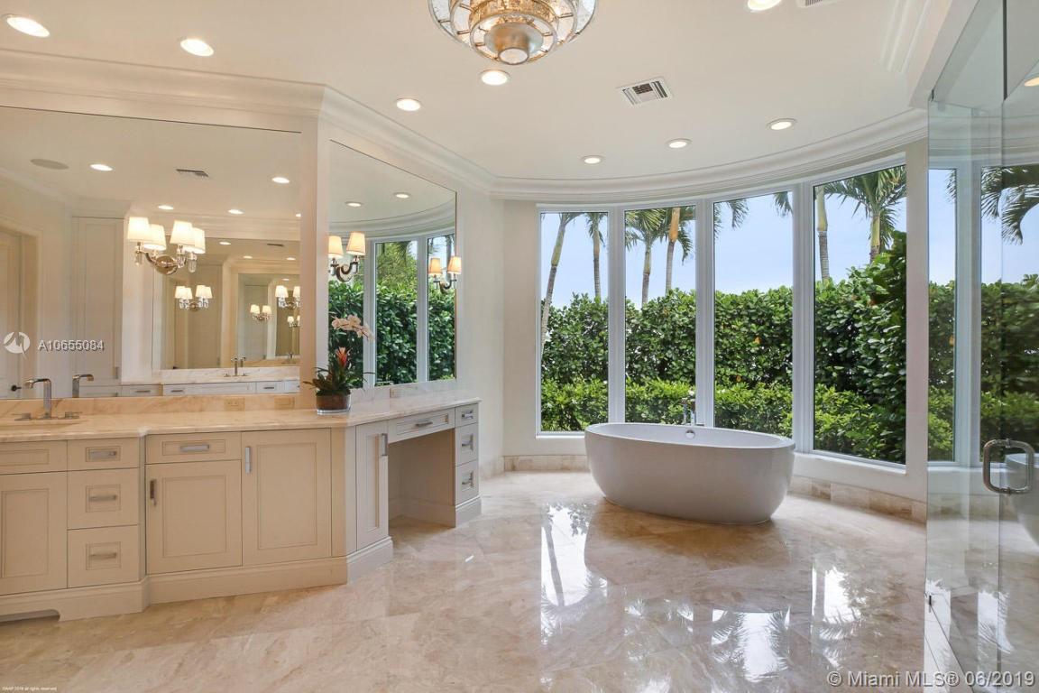 5241 Pennock Point Road Jupiter, FL 33458 - Photo 26 of 51 a large white kitchen with large windows and sink