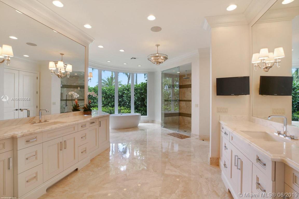 5241 Pennock Point Road Jupiter, FL 33458 - Photo 27 of 51 a large bathroom with a large mirror vanity and shower