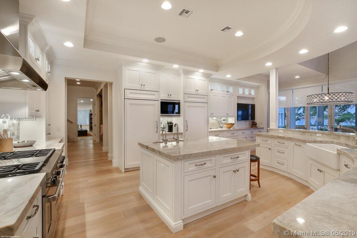 5241 Pennock Point Road Jupiter, FL 33458 - Photo 9 of 51 a kitchen with stainless steel appliances kitchen island granite countertop a lot of counter top space