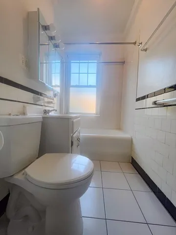 a bathroom with a toilet a sink and bathtub