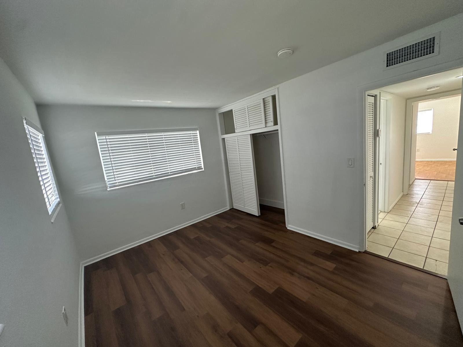 7330 Southwest 82nd Street, Unit B115 Miami, FL 33143 - Photo 14 of 19 a view of an empty room with wooden floor and a window