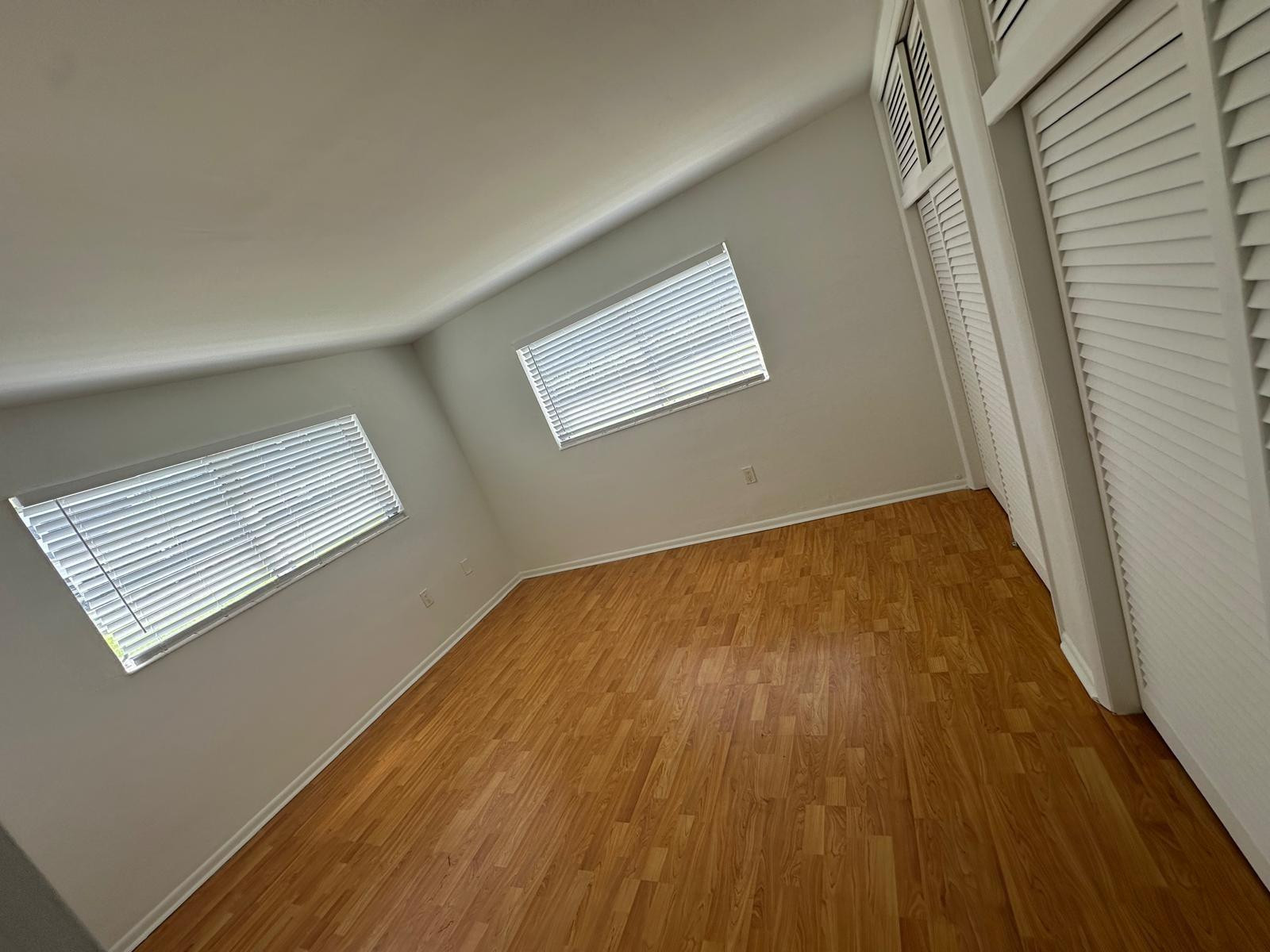 7330 Southwest 82nd Street, Unit B115 Miami, FL 33143 - Photo 17 of 19 a view of empty room with wooden floor and fan