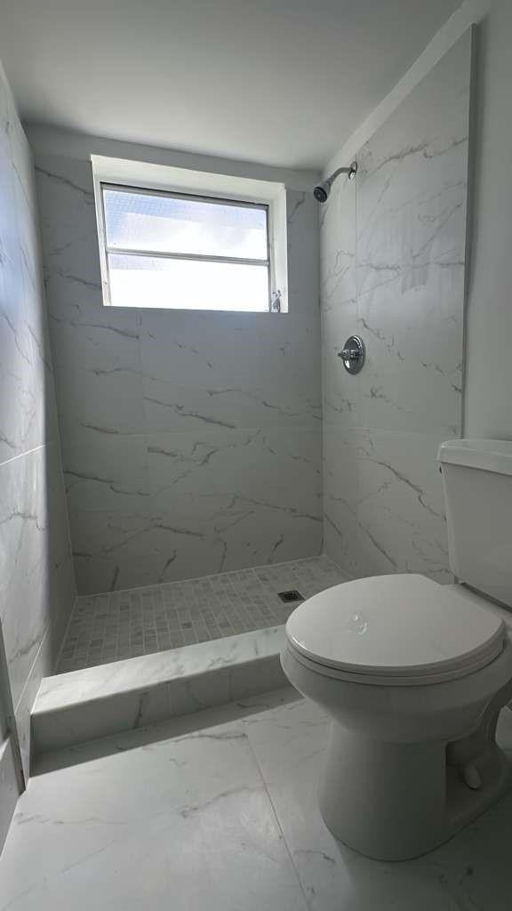 7330 Southwest 82nd Street, Unit B115 Miami, FL 33143 - Photo 9 of 19 a bathroom with a toilet and a shower