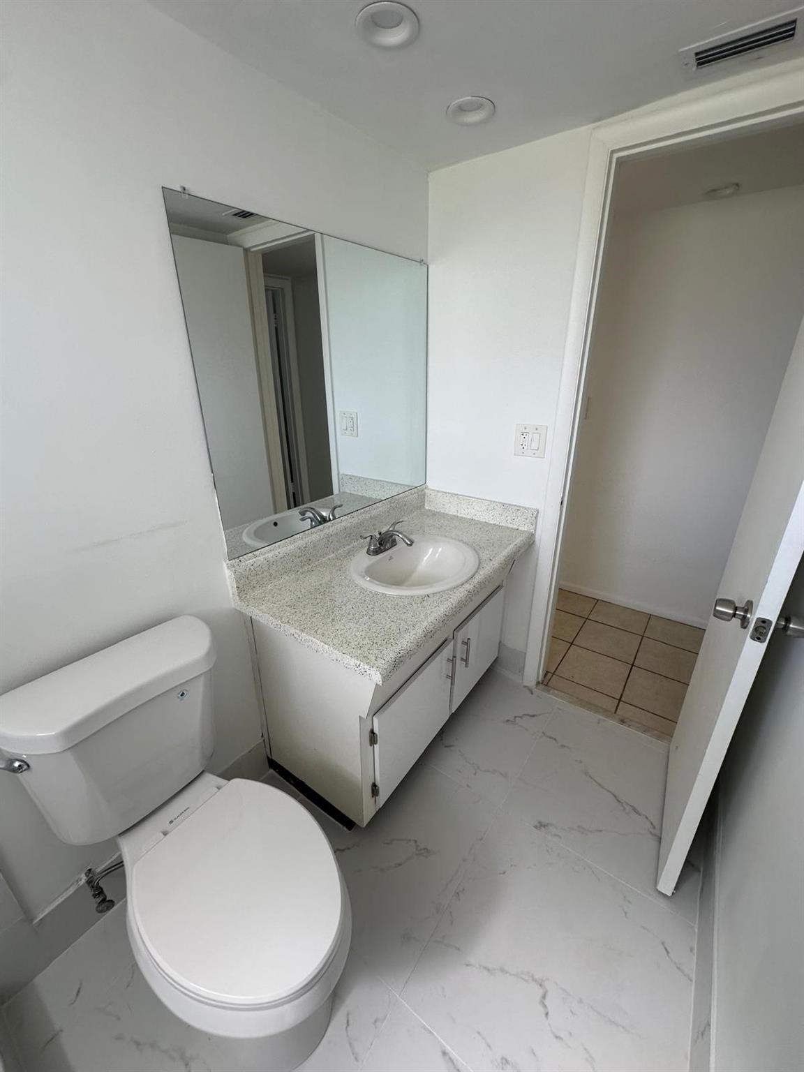 7330 Southwest 82nd Street, Unit B115 Miami, FL 33143 - Photo 10 of 19 a white toilet sitting next to a bathroom sink