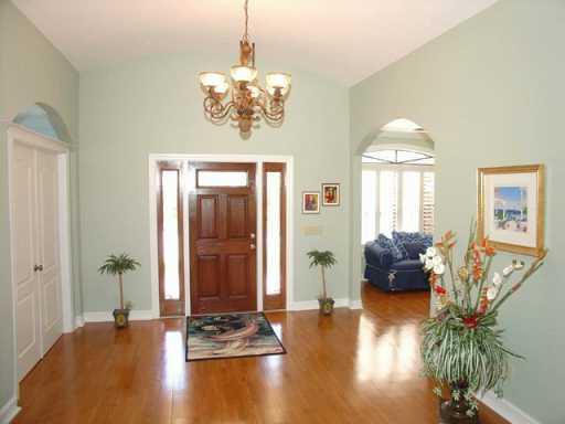 12 Rio Vista Drive Stuart, FL 34996 - Photo 2 of 8 a view of a livingroom with furniture window wooden floor and a chandelier