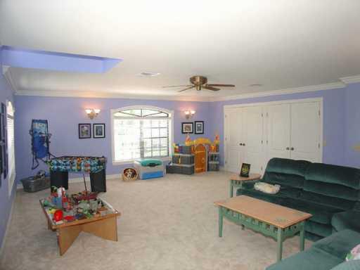 12 Rio Vista Drive Stuart, FL 34996 - Photo 4 of 8 a living room with furniture gym equipment and a window