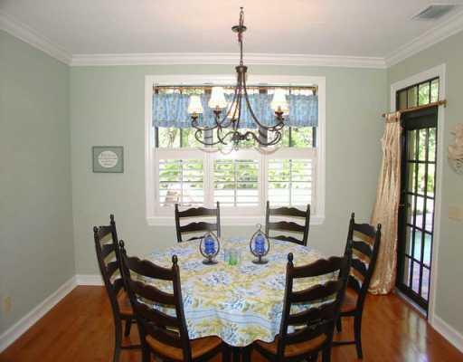 12 Rio Vista Drive Stuart, FL 34996 - Photo 5 of 8 a dining room with furniture a chandelier and wooden floor