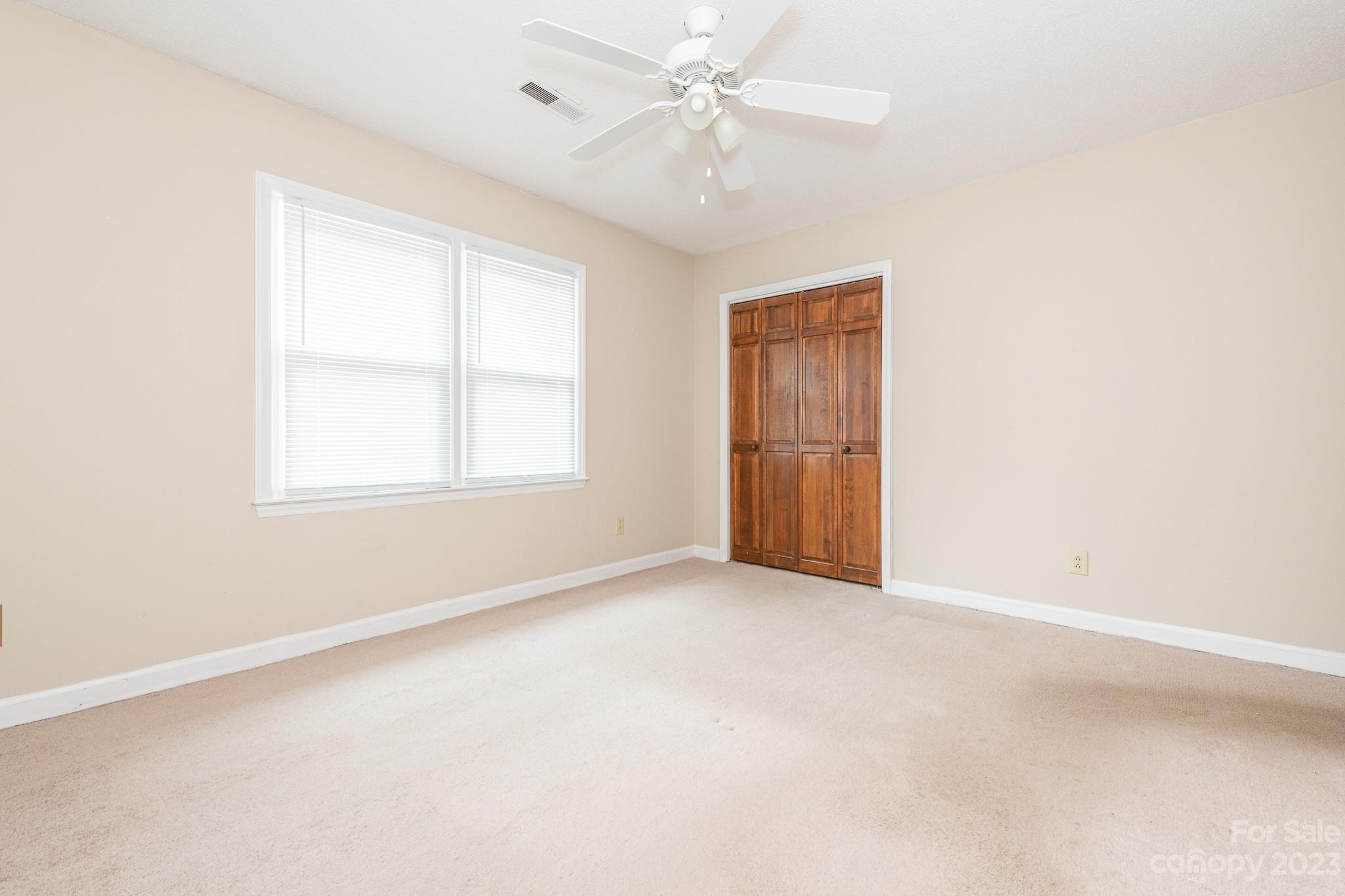 2502 Round Table Road, Unit A Monroe, NC 28110 - Photo 25 of 34 an empty room with windows and fan