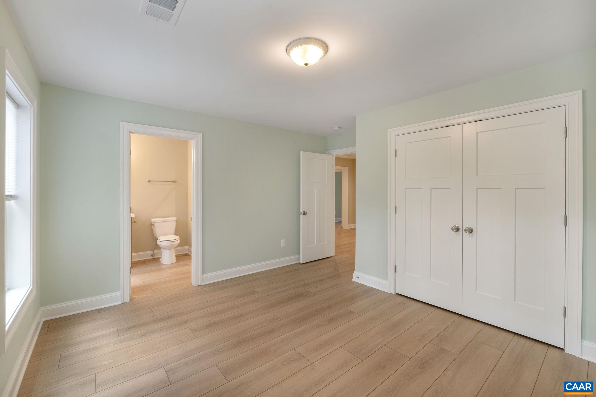 57-22a Old Three Notch'd Road Charlottesville, VA 22901 - Photo 13 of 27 an empty room with wooden floor and windows