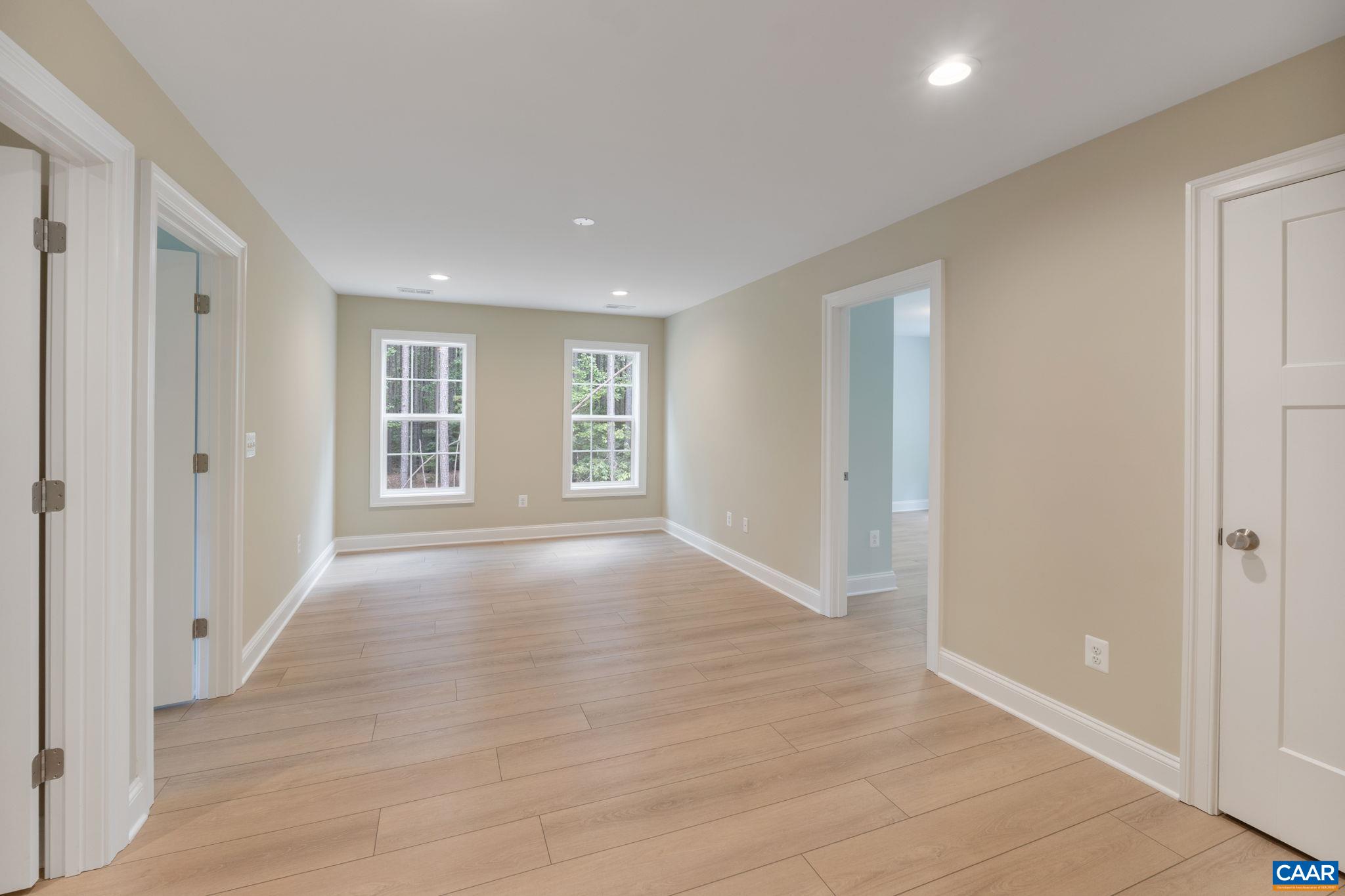 57-22a Old Three Notch'd Road Charlottesville, VA 22901 - Photo 15 of 27 an empty room with wooden floor and windows