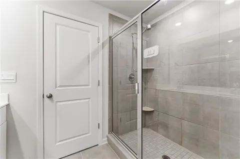 a bathroom with a glass door shower