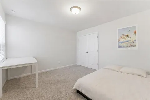 a bedroom with a bed and a desk