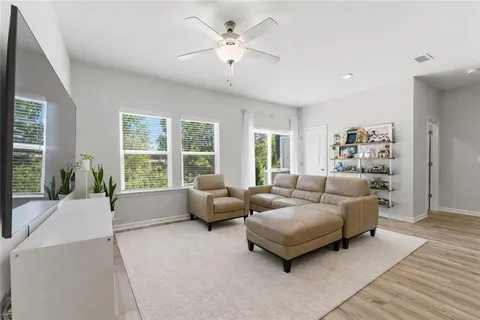 a living room with furniture and large windows
